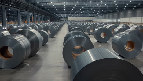 rows of metal coils in a large industrial warehouse