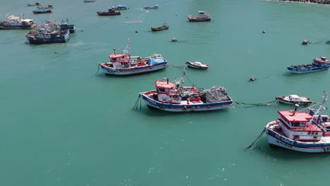 aerial flying over moored fishing boats in port of san antonio in chile