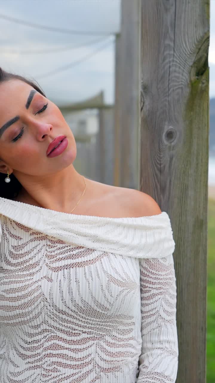 Woman on a boardwalk overlooking the beach