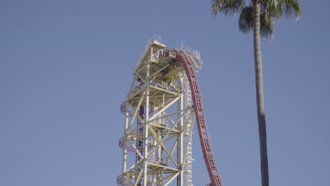 epic footage of a roller coaster climbing a lift hill and plunging down a large drop