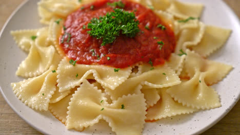 farfalle pasta in tomato sauce with parsley - italian food style