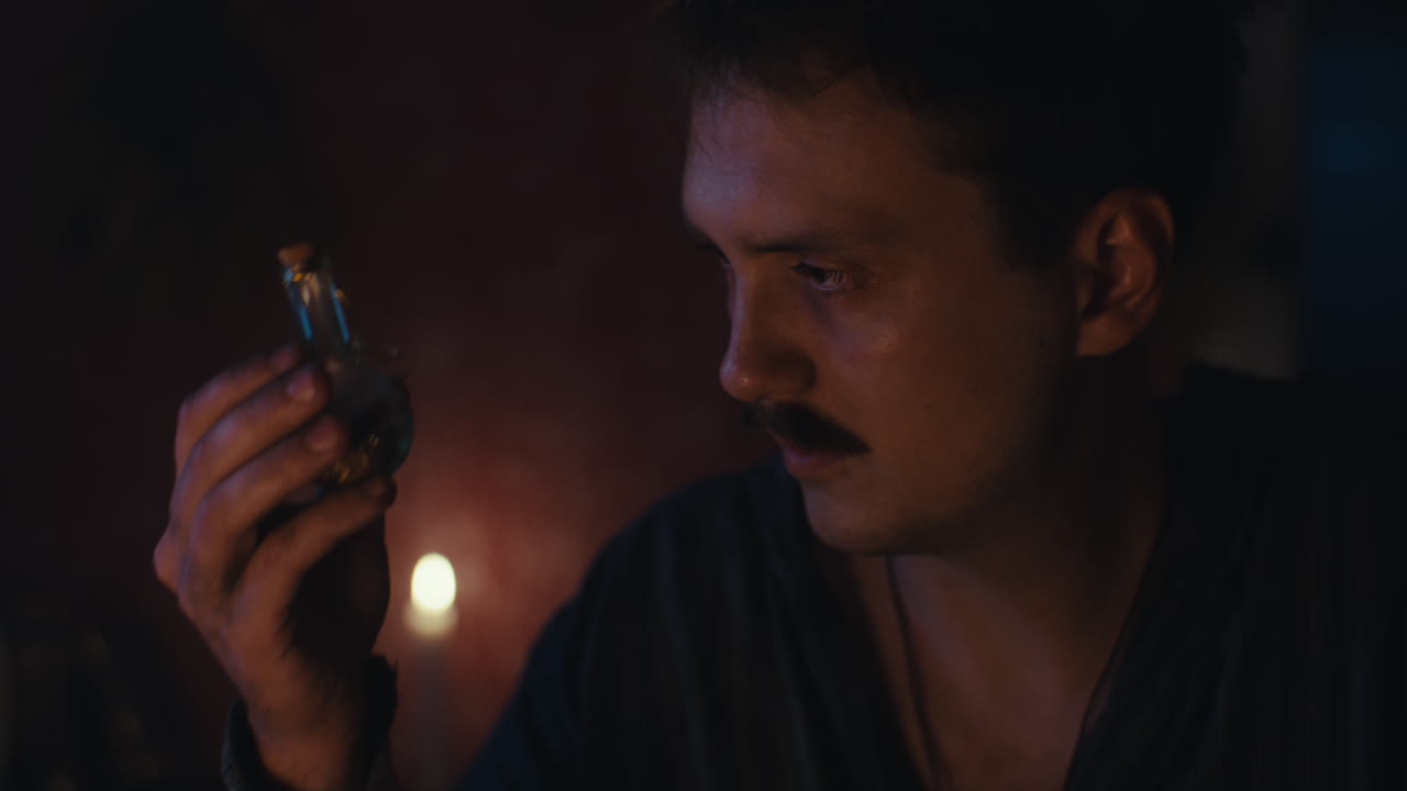 Man with Mustache in Dimly Lit Room