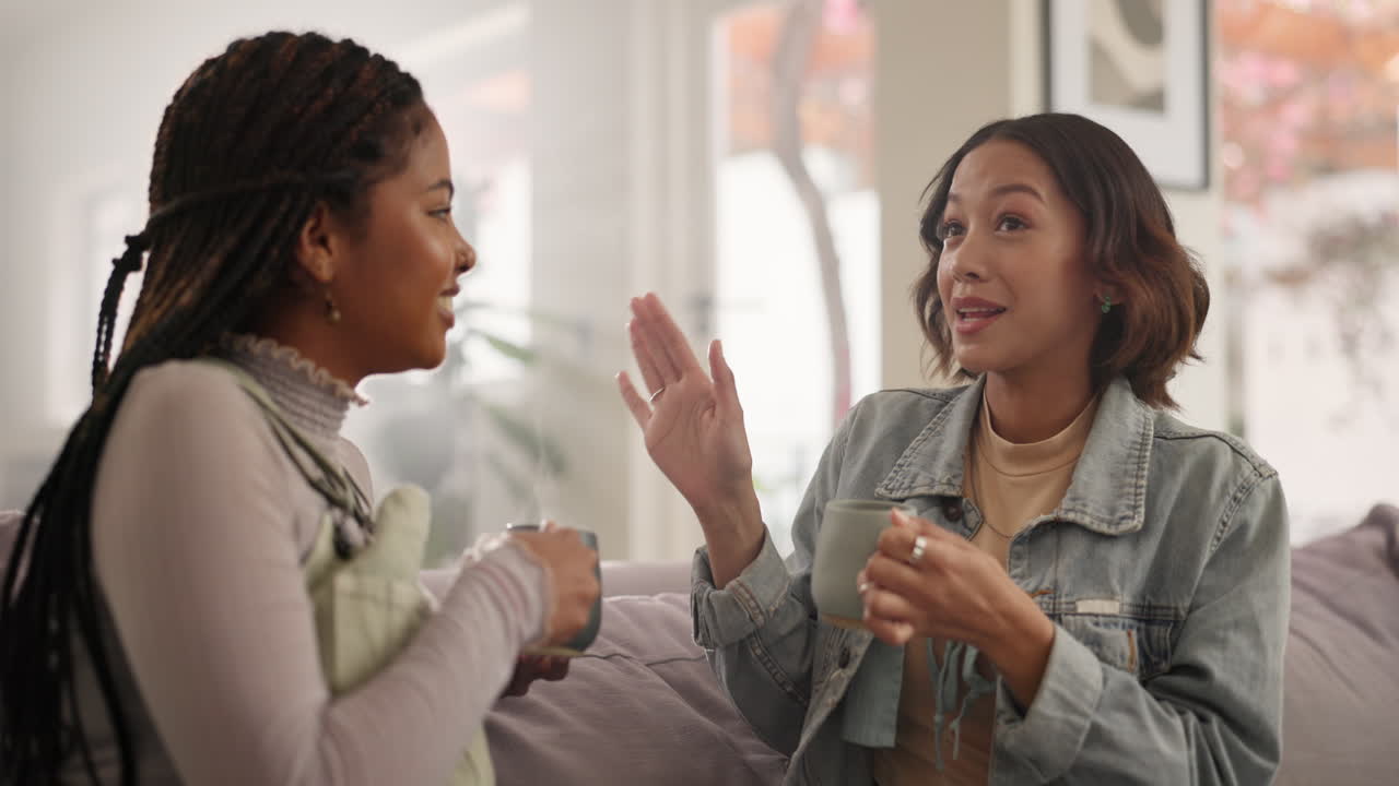Two friends having coffee and a conversation indoors