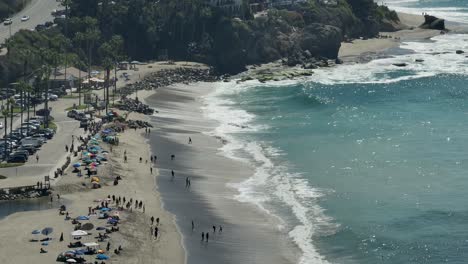 aerial view of waves crashing on aliso beach, in laguna beach, california