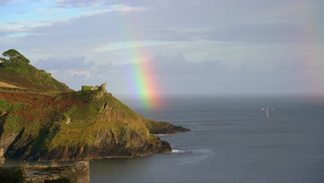 Coast-rainbow-over-a-headland-in-Polruan-in-Cornwall