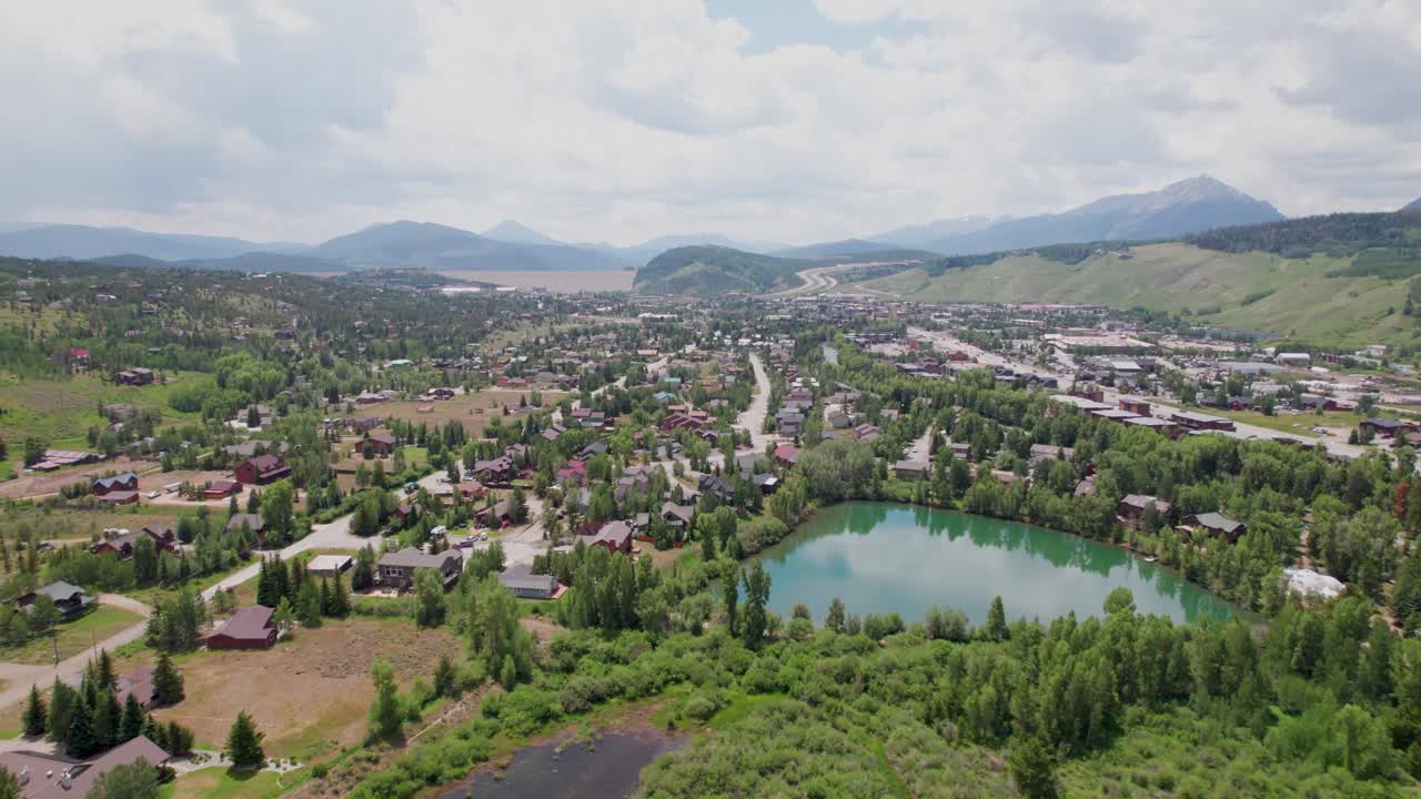 Aerial flight over Silverthorne Colorado. Camer flies over trees and ponds and shows parts of Silverthorne.