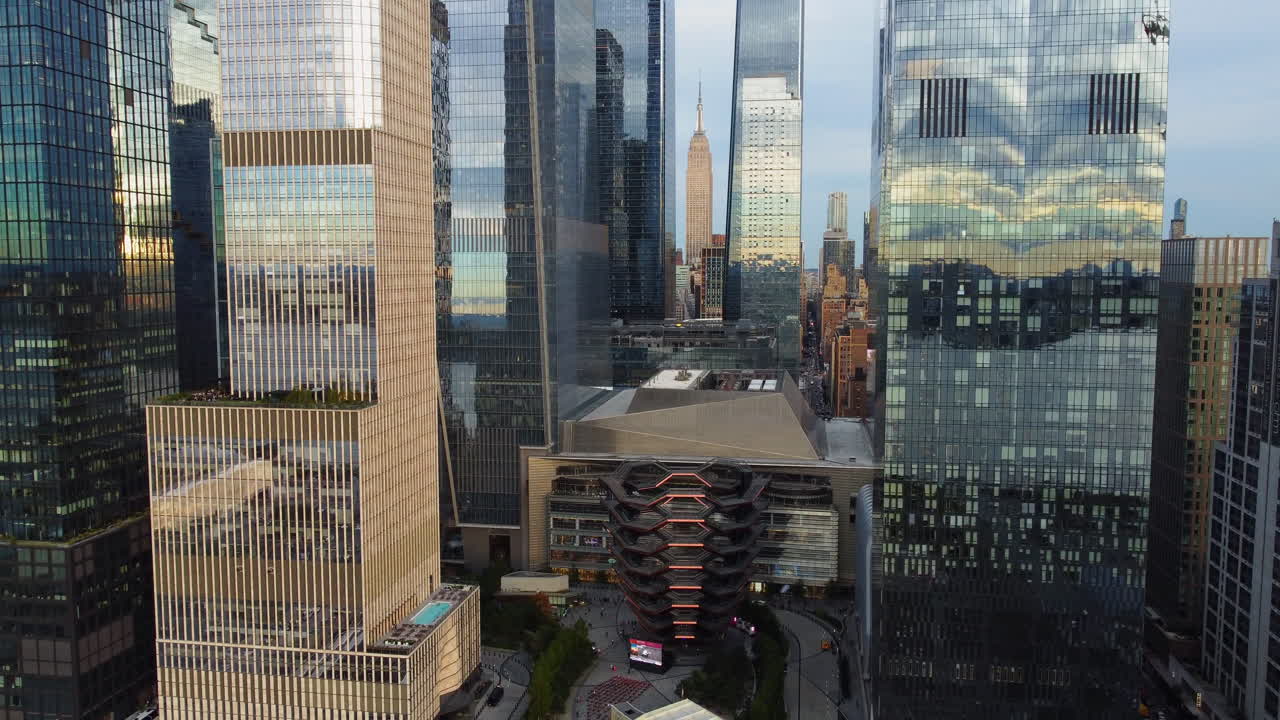 Aerial view backwards in front of high-rise in Hudson Yards, sunset in New York