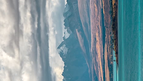 cloudscape timelapse over shore of lake pukaki, new zealand, vertical video