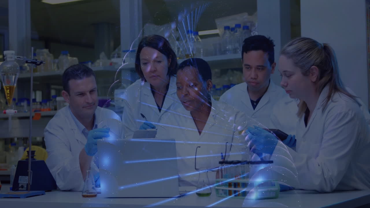 Analyzing data with digital animation overlay, scientists working in laboratory