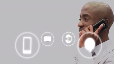 animation of icons and data processing over african american businessman in office