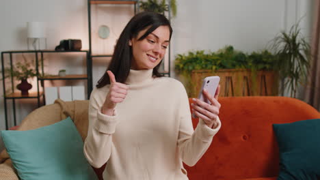 Young-woman-blogger-taking-selfie-on-smartphone,-communicating-video-call-online-with-subscribers