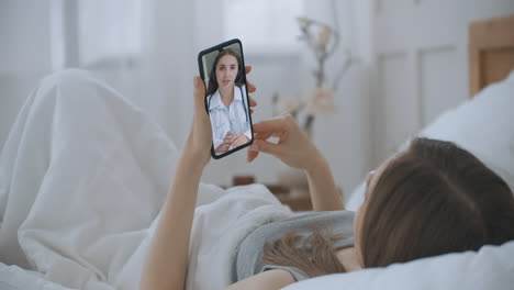 Frau-Nutzt-Online-Chat,-Um-Mit-Familientherapeuten-Zu-Sprechen-Und-Mögliche-Symptome-Während-Einer-Coronavirus-Pandemie-Zu-überprüfen.-Frau-Nutzt-Medizinische-App-Auf-Smartphone-Und-Berät-Sich-Per-Videokonferenz-Mit-Dem-Arzt.