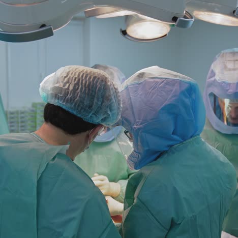 in surgery. medical team performing operation in hospital operating theater. working with surgical instruments