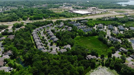 drone shot of a housing development next to a highway or freeway