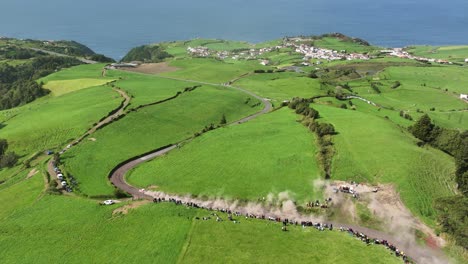 epic aerial of rally car drifting down dusty mountain dirt road, azores rallye