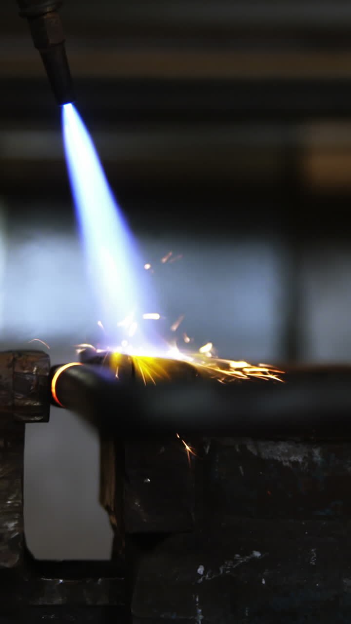 Close-up of welder using welding torch