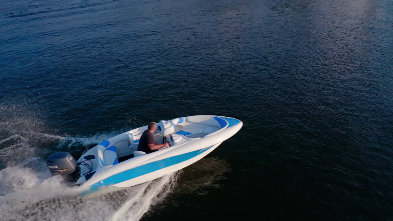 Motor boat floating on river. Aerial view of motor boat sailing along the city river
