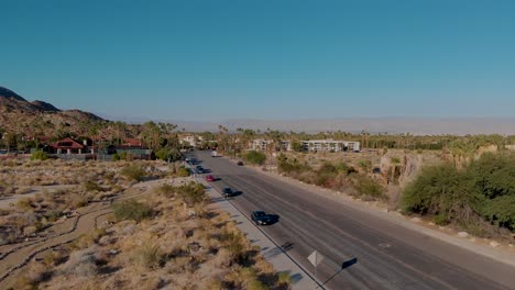 establishing shot rising up outside small desert town near road