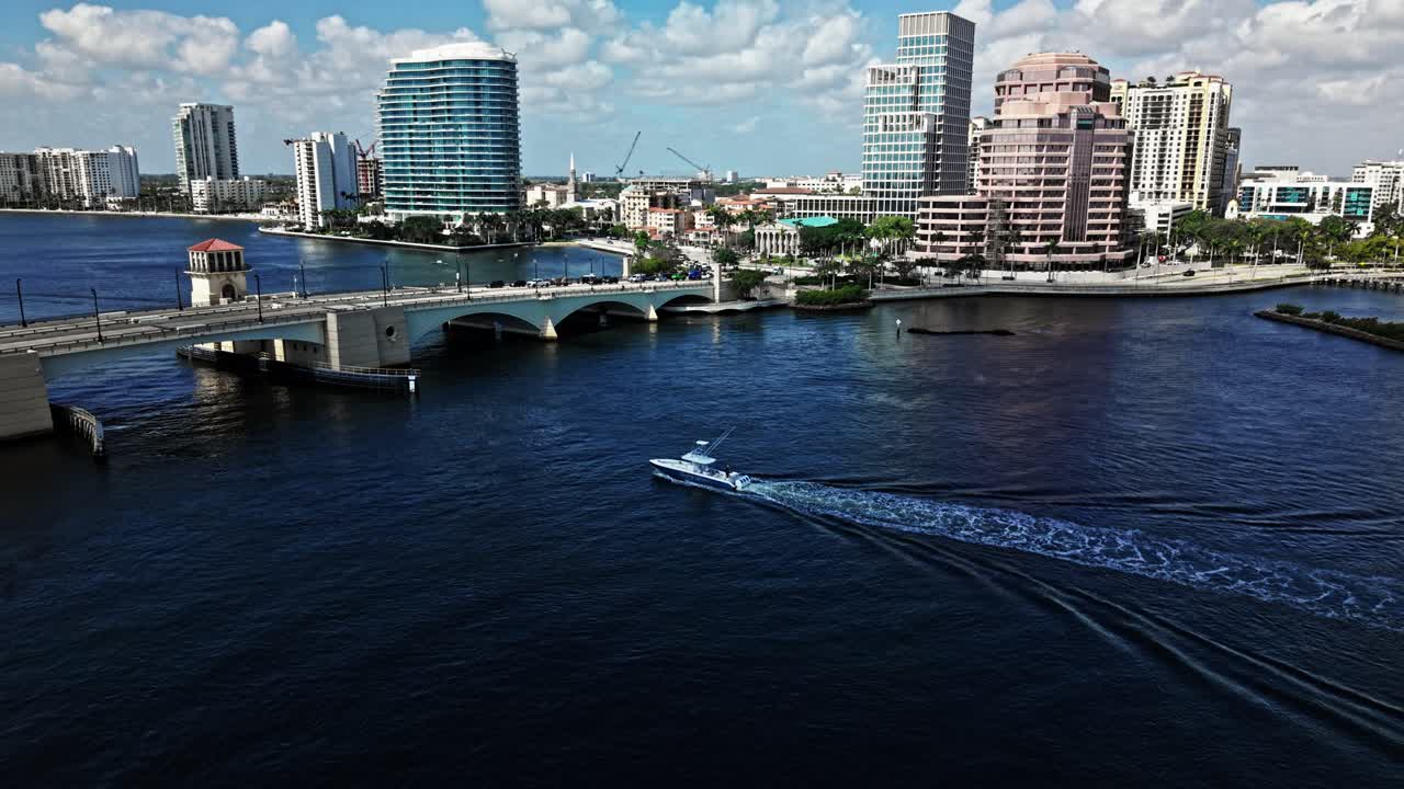 Crane down drone shot of Royal Park Bridge with One Flagler and Phillips Point building in West Palm Beach, Florida, USA