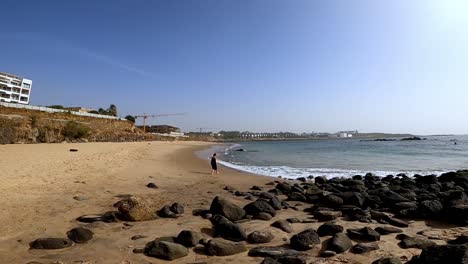 Lone-Woman-On-The-Seashore-Of-Dakar-Beach-During-Sunrise-In-Senegal,-Africa