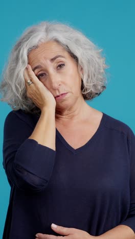 senior woman suffering from headache or stomach ache