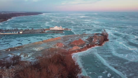 A-stone-quarry-and-dock-along-the-shoreline-on-Kingsville,-Ontario-during-sunset-in-winter