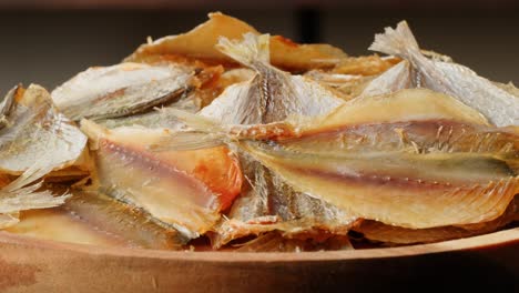 dried fish on wooden plate