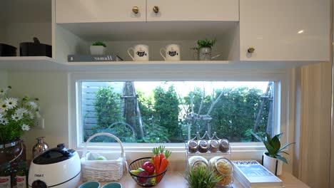 simple and stylish kitchen with utensil and garden view, no people