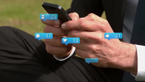 Speech-bubbles-with-increasing-numbers-against-mid-section-of-businessman-using-smartphone