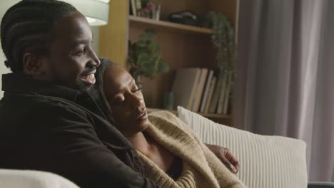 couple at home sitting on sofa in lounge with man comforting unhappy woman 1