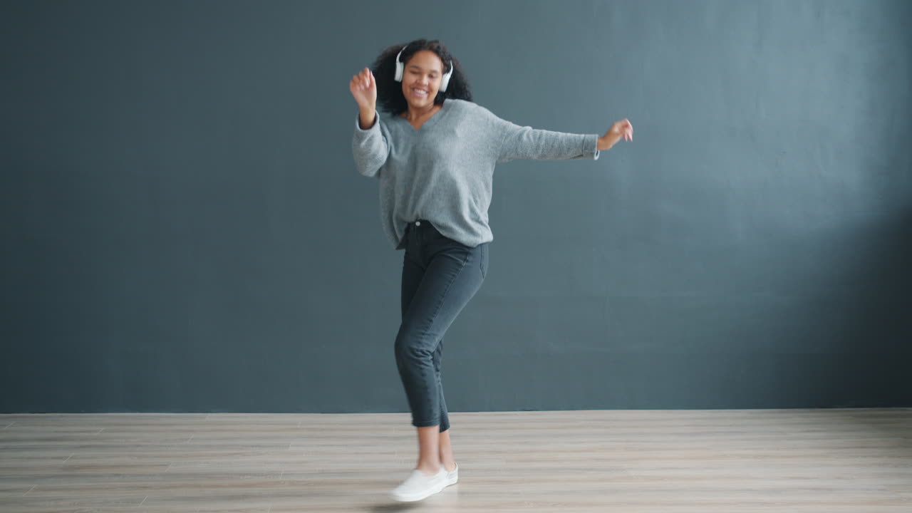 Happy woman dancing with headphones