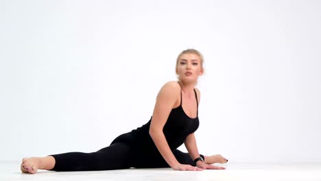 young woman doing sports fitness on mat at home fitness trainer or instructor in sportswear young woman doing sports fitness on mat at home fitness trainer or instructor in sportswear performs exercises to stay fit and healthy fitness and wellness concept