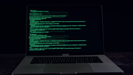 code on a laptop computer monitor in a dark room