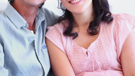 Man-and-a-woman-laughing-while-sitting-together