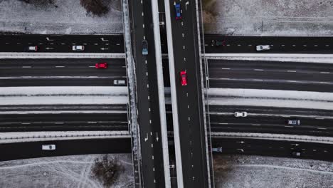 top-down static drone shot of snow-covered highway interchange in winter, latvia