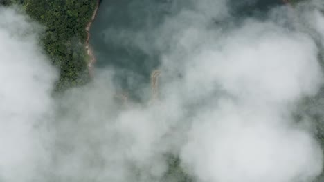 thick fog over lake in dense forest mountains at lake danao natural park on leyte island, philippines