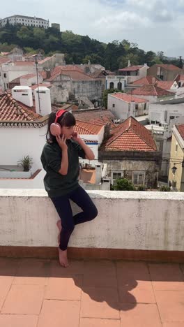 Girl with Headphones on a Rooftop