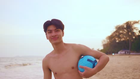 man on the beach with soccer ball