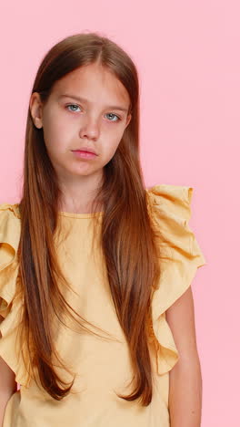 child girl kid smiling with finger on lips making hush sign as if keeping secret asking for silence