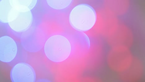 defocused view of flickering, pink and blue lights