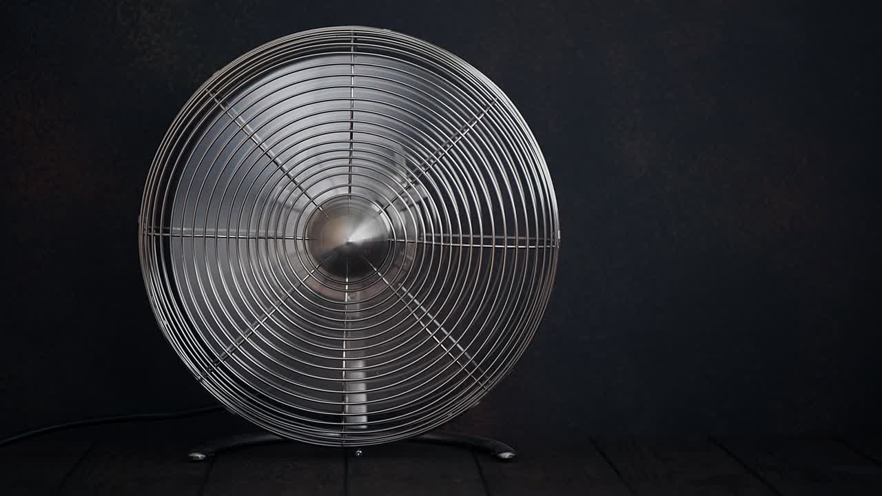 Rotating home fan on a wooden table