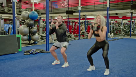 woman and man train on sports training equipment in a fitness gym