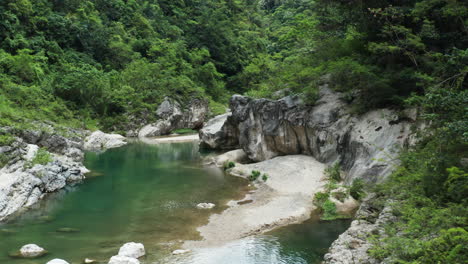 flying over shallow water of nizao river flowing through the wilderness of dominican republic