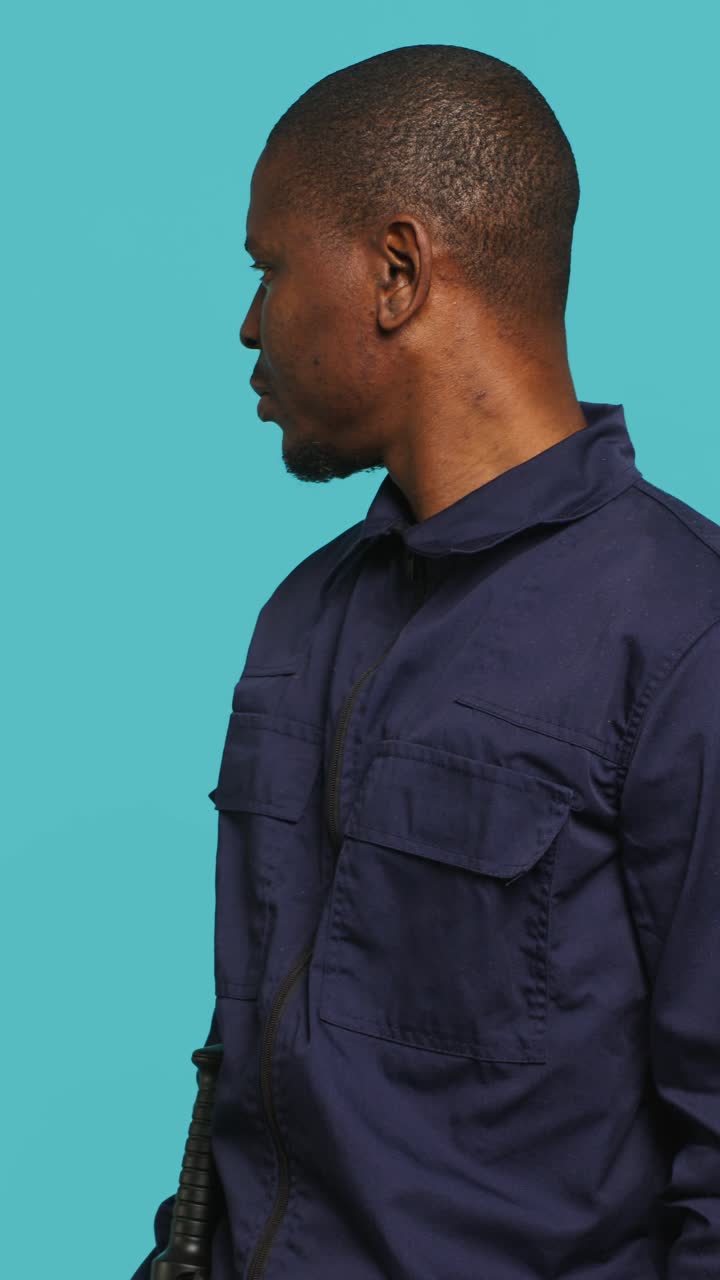 Serious African American Man in Uniform Looking Around