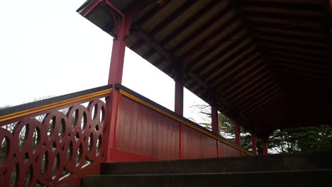 ornate victorian colourful wooden swiss bridge grand peaceful public park gardens low angle dolly left