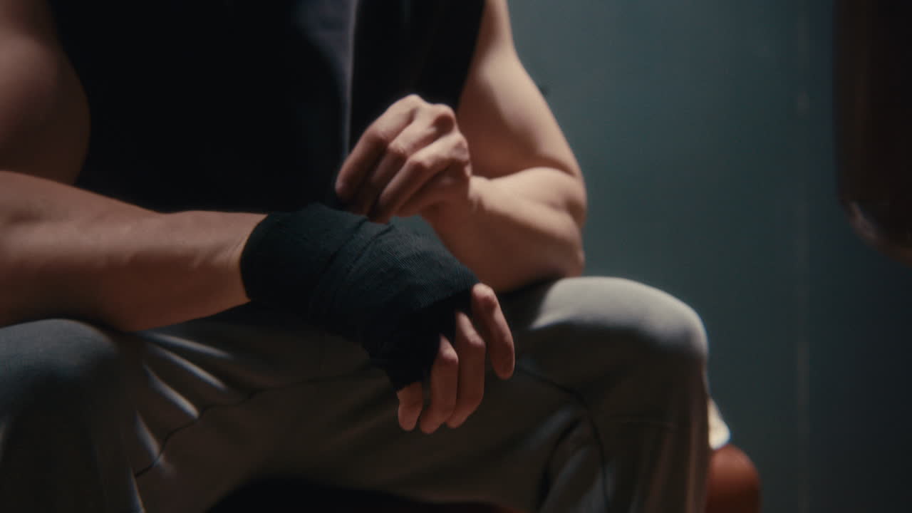 Man putting on boxing wraps