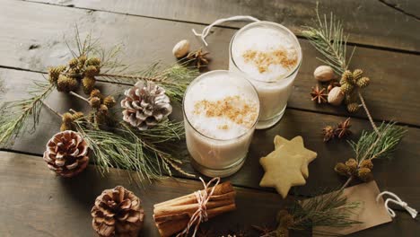 video of cups of hot chocolate with cinnamon over wooden background