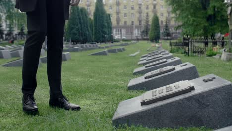 man walking through cemetery