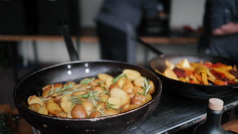 pan with rosemary potatoes on gas stove at outdoor event