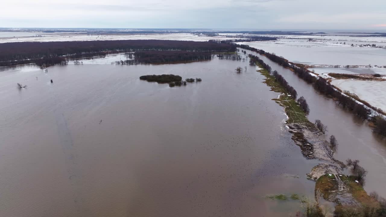Panoramic view, the river overflowing its bed and flooding the meadows with water. Lithuania Europe.